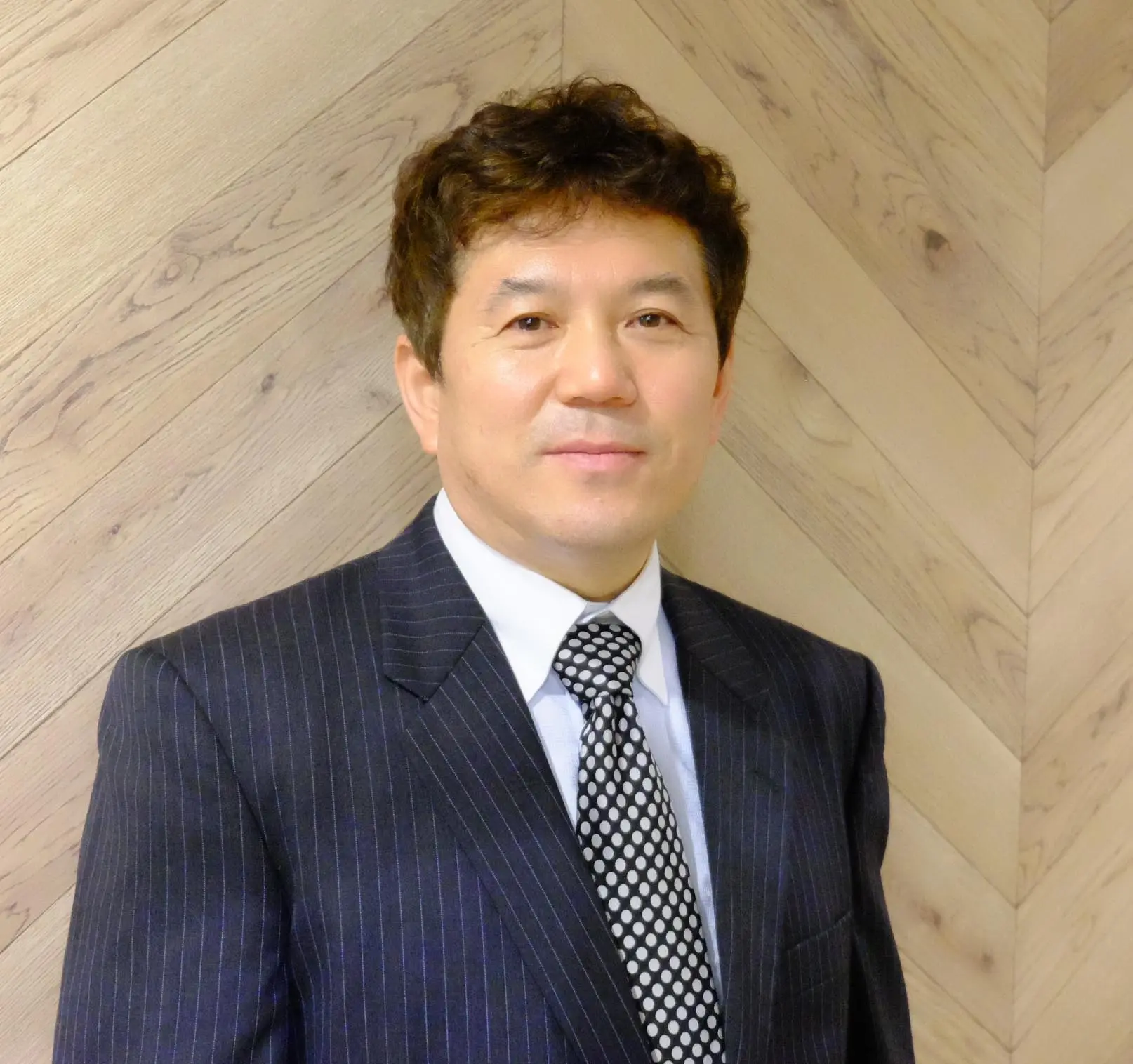 Hidemitsu Kuruma, President & CEO of AIC Corporation